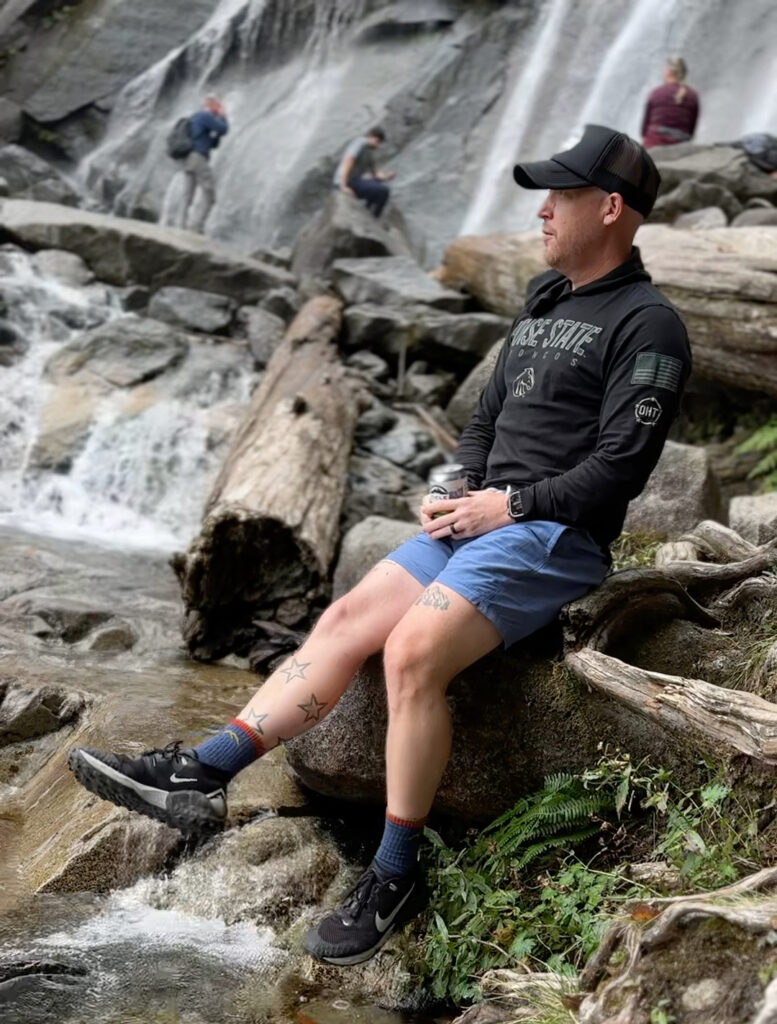 Teacher Forrest contemplates his tiktok journey upon a log